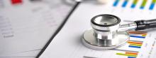 A stethoscope resting on some paper with biometric data.
