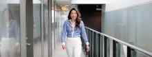 Dr. Mary De Vera walking down a hall.