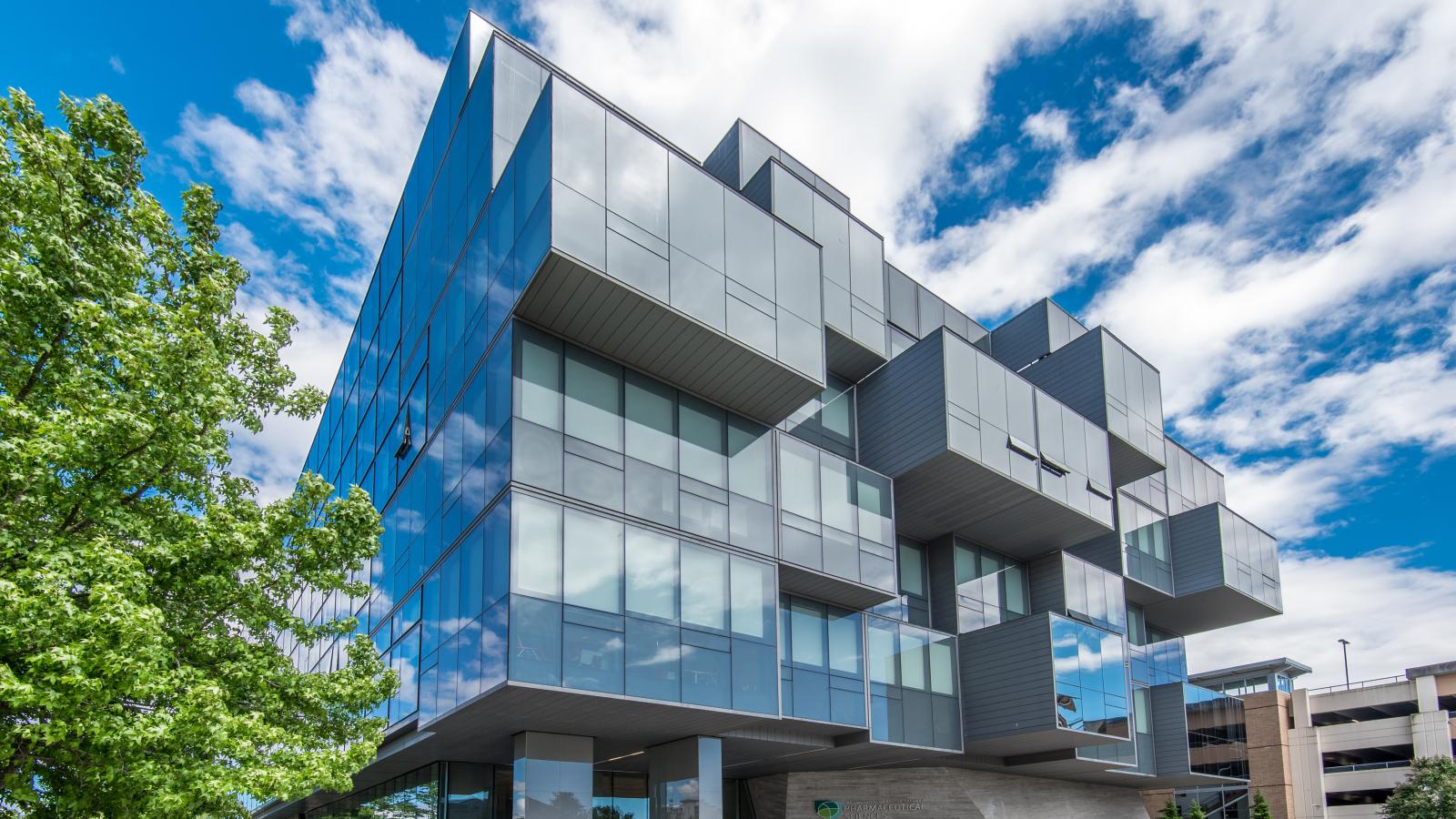 The exterior of the Pharmaceutical Sciences Building on a sunny day.