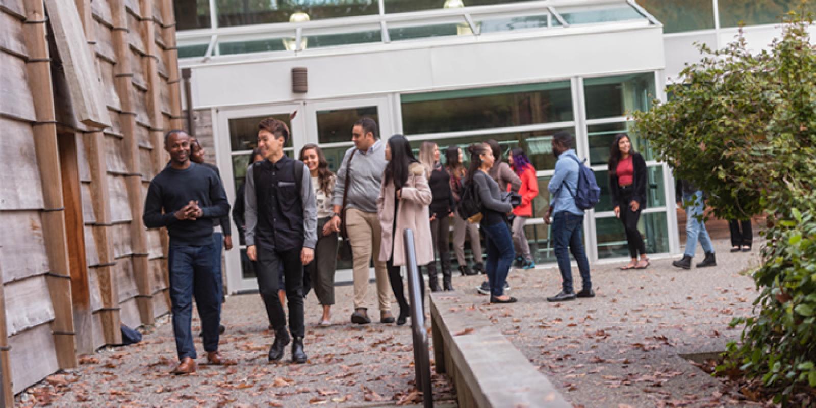 A group of students leaving class outside of the UBC First Nations Longhouse.