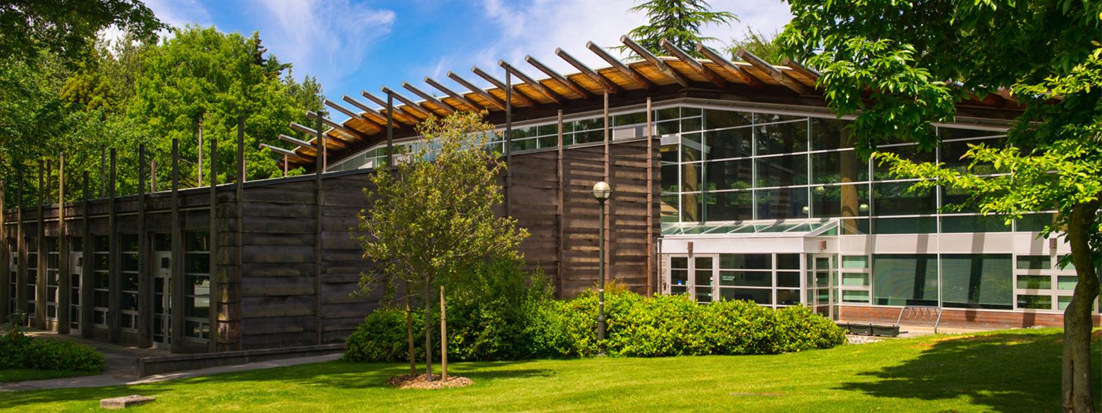 The exterior of the UBC First Nations Longhouse on a sunny day.